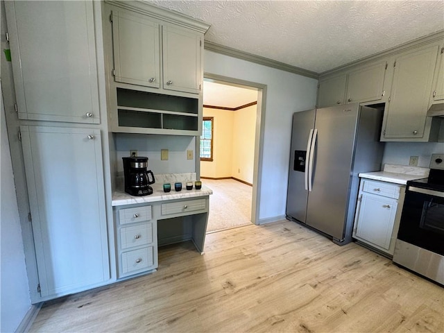 kitchen with appliances with stainless steel finishes, crown molding, light countertops, gray cabinets, and light wood-type flooring