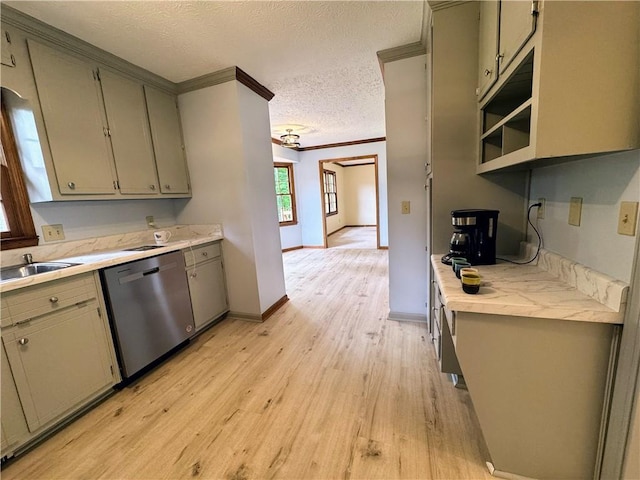 kitchen with stainless steel dishwasher, a sink, light wood-type flooring, ornamental molding, and light countertops