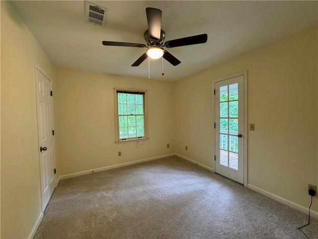 carpeted spare room with healthy amount of natural light, baseboards, and a ceiling fan