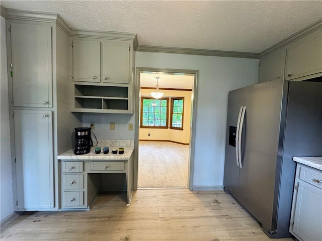 kitchen featuring stainless steel fridge, light wood-style floors, ornamental molding, gray cabinetry, and light countertops