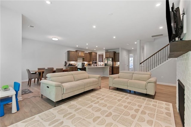 living room with a fireplace and light hardwood / wood-style floors