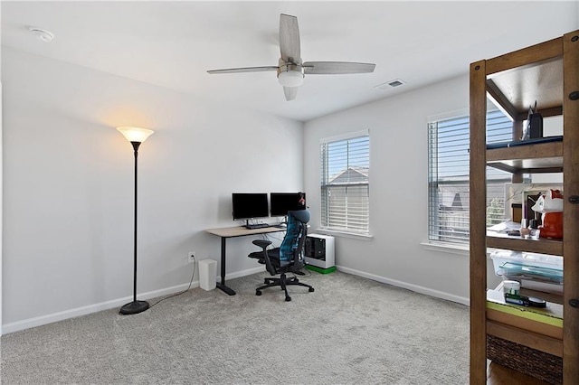 carpeted home office with ceiling fan