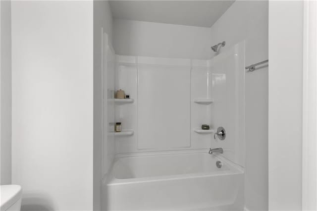 bathroom with toilet and washtub / shower combination