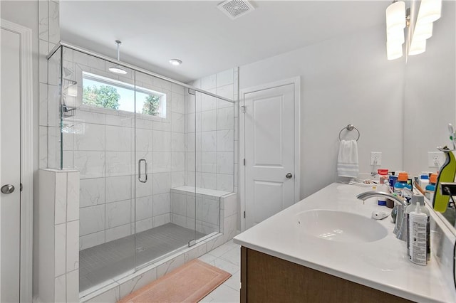 bathroom featuring walk in shower, tile patterned flooring, and vanity