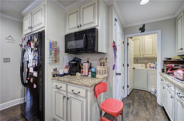 kitchen with black appliances, independent washer and dryer, dark wood-style flooring, and ornamental molding