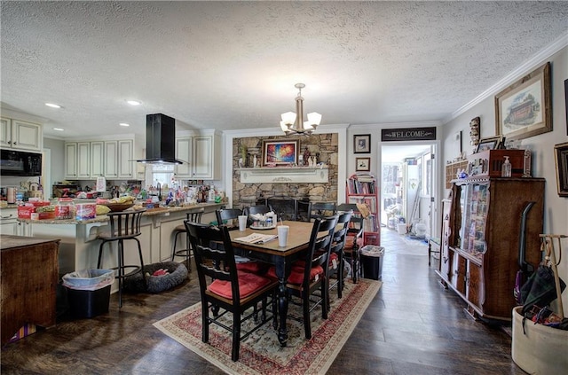 dining room with a chandelier, dark wood finished floors, a textured ceiling, and crown molding