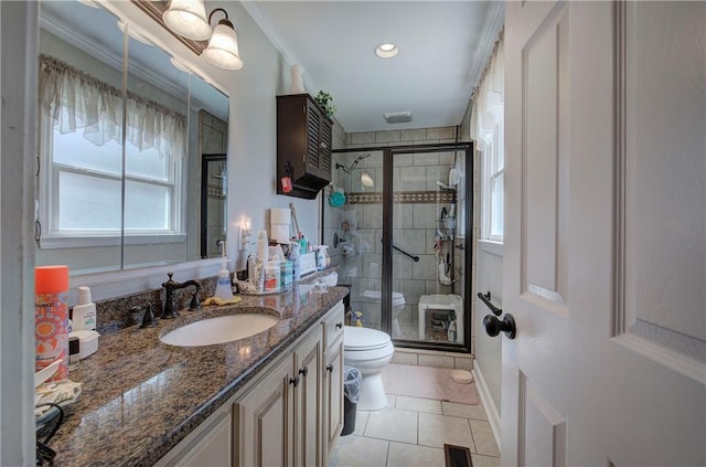 bathroom with visible vents, toilet, a shower stall, and vanity