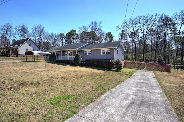 ranch-style house featuring a front lawn, a fenced front yard, a porch, driveway, and a gate