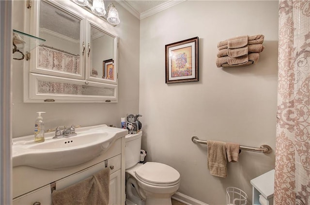 bathroom with baseboards, vanity, toilet, and crown molding