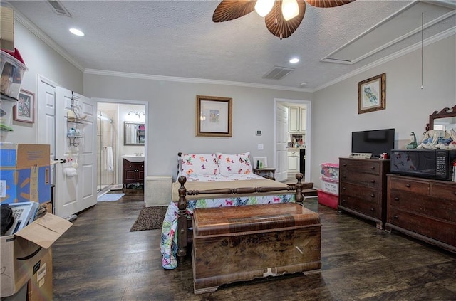 bedroom featuring crown molding, wood finished floors, visible vents, and a textured ceiling