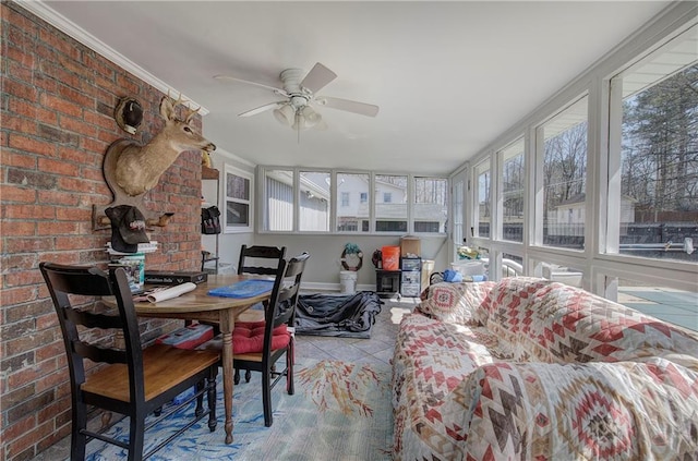 sunroom / solarium featuring a wealth of natural light and a ceiling fan