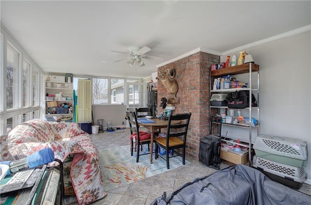 tiled dining space featuring a ceiling fan and crown molding