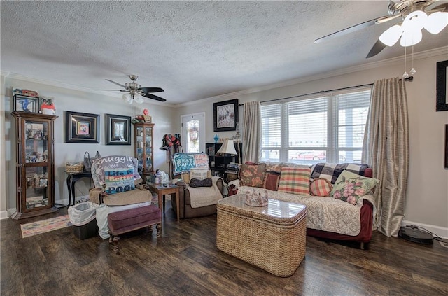 living area featuring wood finished floors, crown molding, a ceiling fan, and baseboards