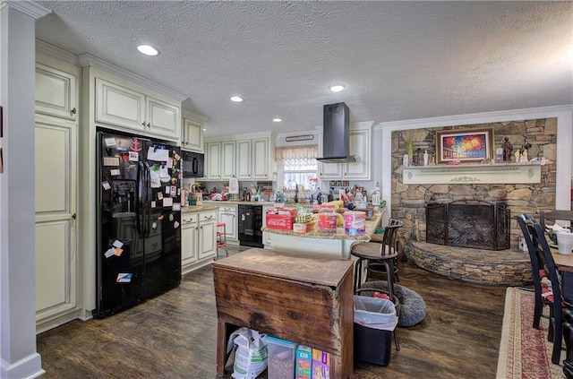 kitchen with dark wood-type flooring, a stone fireplace, range hood, black appliances, and a sink