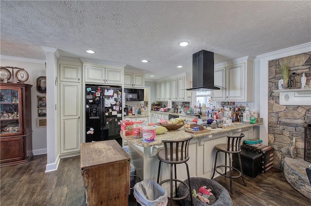 kitchen featuring range hood, a peninsula, black appliances, and dark wood-type flooring