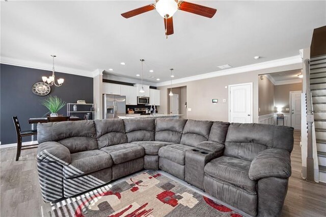 438 Crescent Woode Dr, Dallas, GA 30157 - living room with light wood-style flooring, baseboards, recessed lighting, ceiling fan with notable chandelier, and crown molding