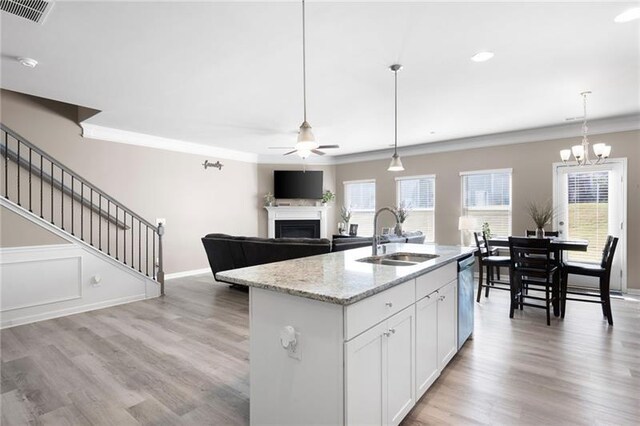 438 Crescent Woode Dr, Dallas, GA 30157 - kitchen with stainless steel dishwasher, a sink, visible vents, ceiling fan with notable chandelier, and a fireplace