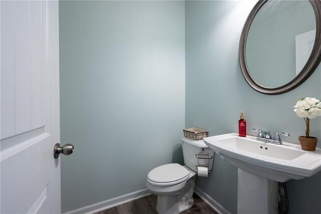 438 Crescent Woode Dr, Dallas, GA 30157 - bathroom with a sink, toilet, wood finished floors, and baseboards
