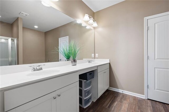 438 Crescent Woode Dr, Dallas, GA 30157 - bathroom featuring a sink, double vanity, baseboards, visible vents, and wood finished floors