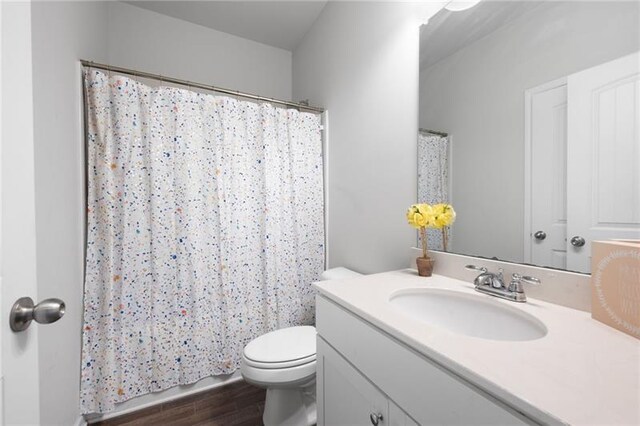 438 Crescent Woode Dr, Dallas, GA 30157 - full bath with toilet, a shower with curtain, vanity, and wood finished floors
