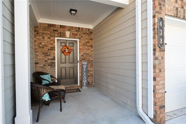 438 Crescent Woode Dr, Dallas, GA 30157 - view of exterior entry with brick siding, a porch, and a garage