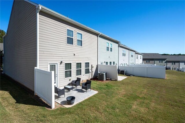 438 Crescent Woode Dr, Dallas, GA 30157 - back of house with fence, a patio area, a lawn, and central AC