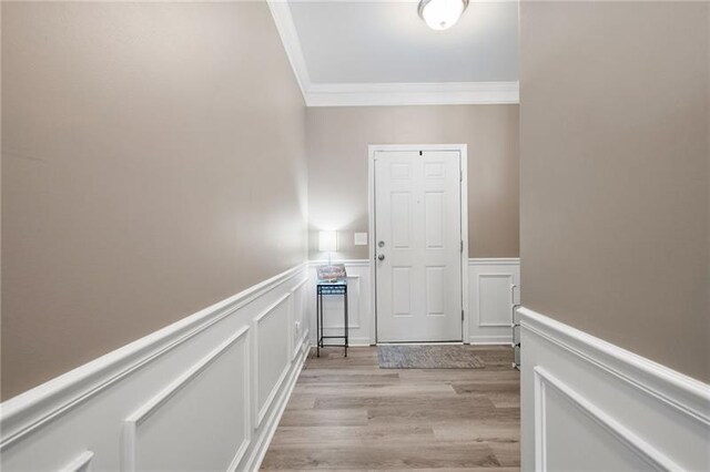438 Crescent Woode Dr, Dallas, GA 30157 - corridor with wainscoting, light wood-style flooring, ornamental molding, and a decorative wall