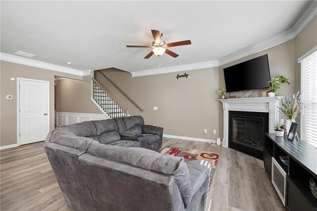 438 Crescent Woode Dr, Dallas, GA 30157 - living area with stairway, ornamental molding, a ceiling fan, and light wood-style flooring