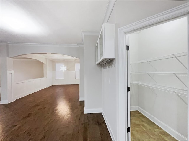 hallway featuring dark hardwood / wood-style flooring and crown molding