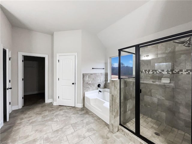 bathroom featuring shower with separate bathtub and vaulted ceiling