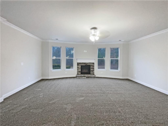 unfurnished living room with crown molding, a stone fireplace, carpet flooring, and ceiling fan