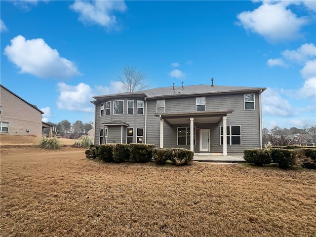 rear view of property with a yard and a patio