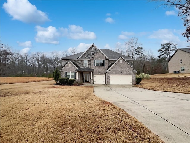 view of front property featuring a garage and a front yard