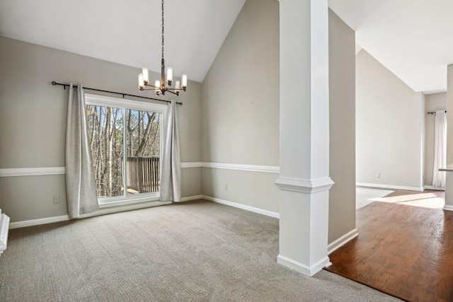 unfurnished room featuring vaulted ceiling, carpet floors, and a notable chandelier