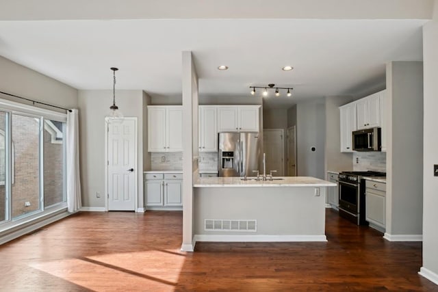 kitchen with white cabinets, appliances with stainless steel finishes, and sink