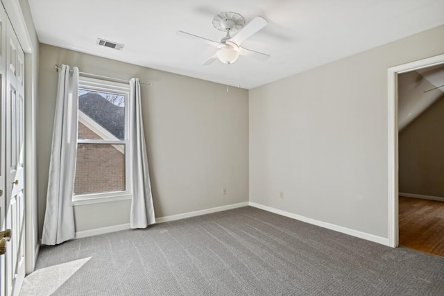 empty room featuring ceiling fan and light colored carpet