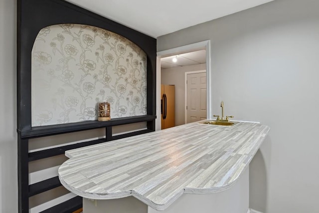 bar with sink and stainless steel refrigerator