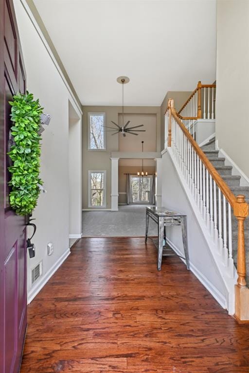 foyer entrance with ceiling fan and dark hardwood / wood-style floors