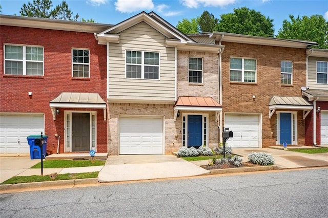 view of front facade featuring driveway, brick siding, and a garage