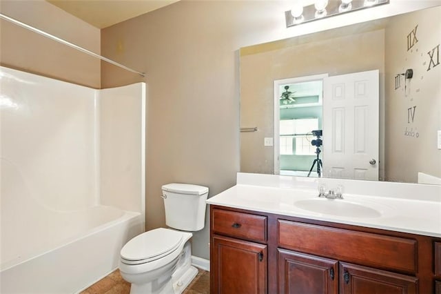 bathroom featuring toilet, washtub / shower combination, tile patterned flooring, and vanity