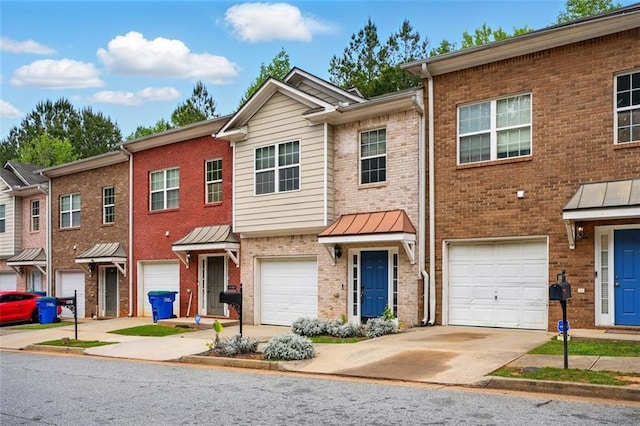 view of front of home with driveway, brick siding, and a garage