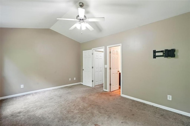 unfurnished bedroom featuring baseboards, carpet flooring, a ceiling fan, and vaulted ceiling