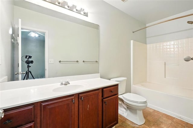 bathroom featuring toilet,  shower combination, and vanity