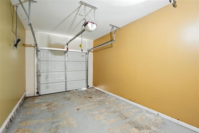 garage with baseboards and a garage door opener