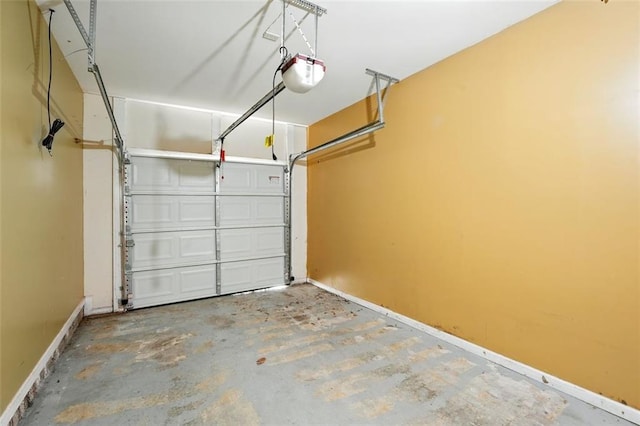 garage featuring baseboards and a garage door opener