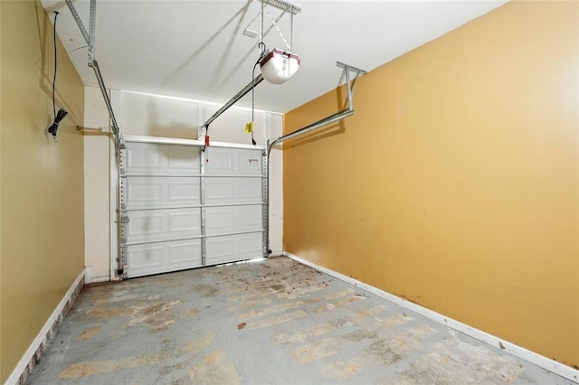 garage featuring baseboards and a garage door opener