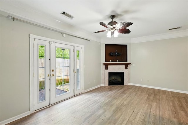 unfurnished living room with crown molding, visible vents, and wood finished floors