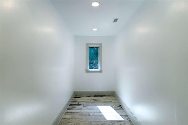 empty room with baseboards, light wood-style flooring, and recessed lighting
