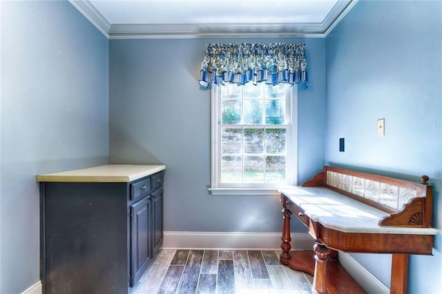 dining space with ornamental molding, baseboards, and wood finished floors