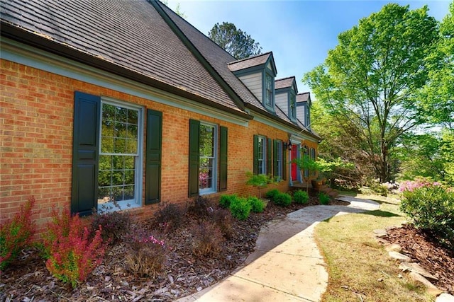 view of side of property with brick siding